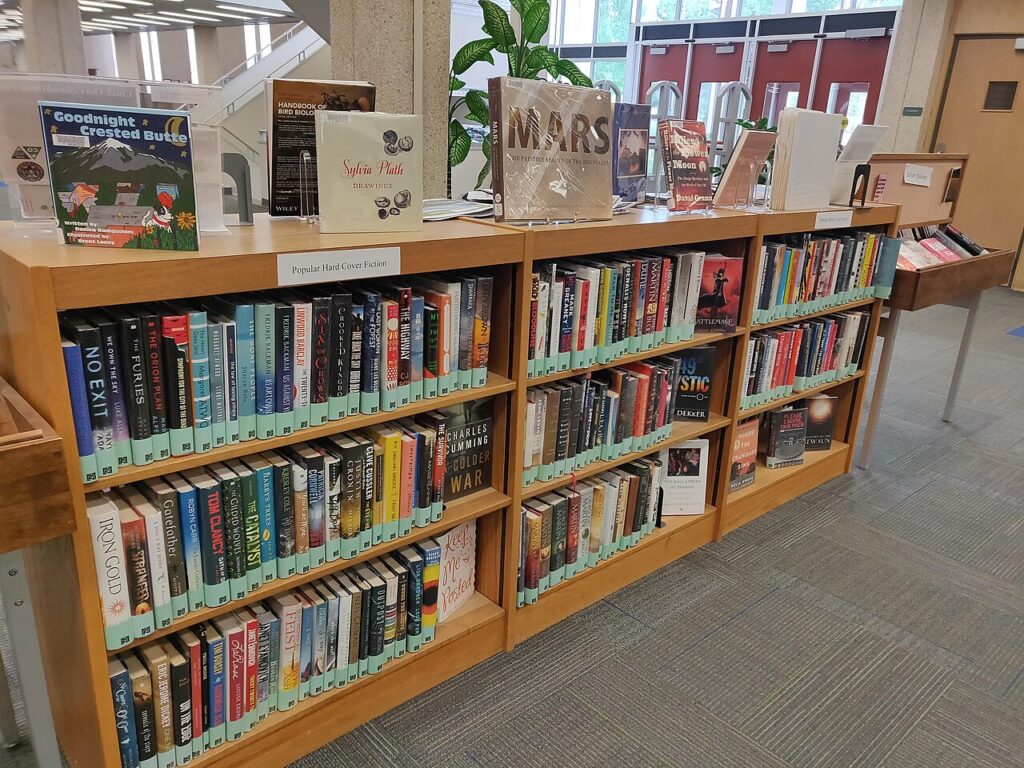 Книги на библиотечной полке: книгу берут с полки, из шкафа — из шкафа